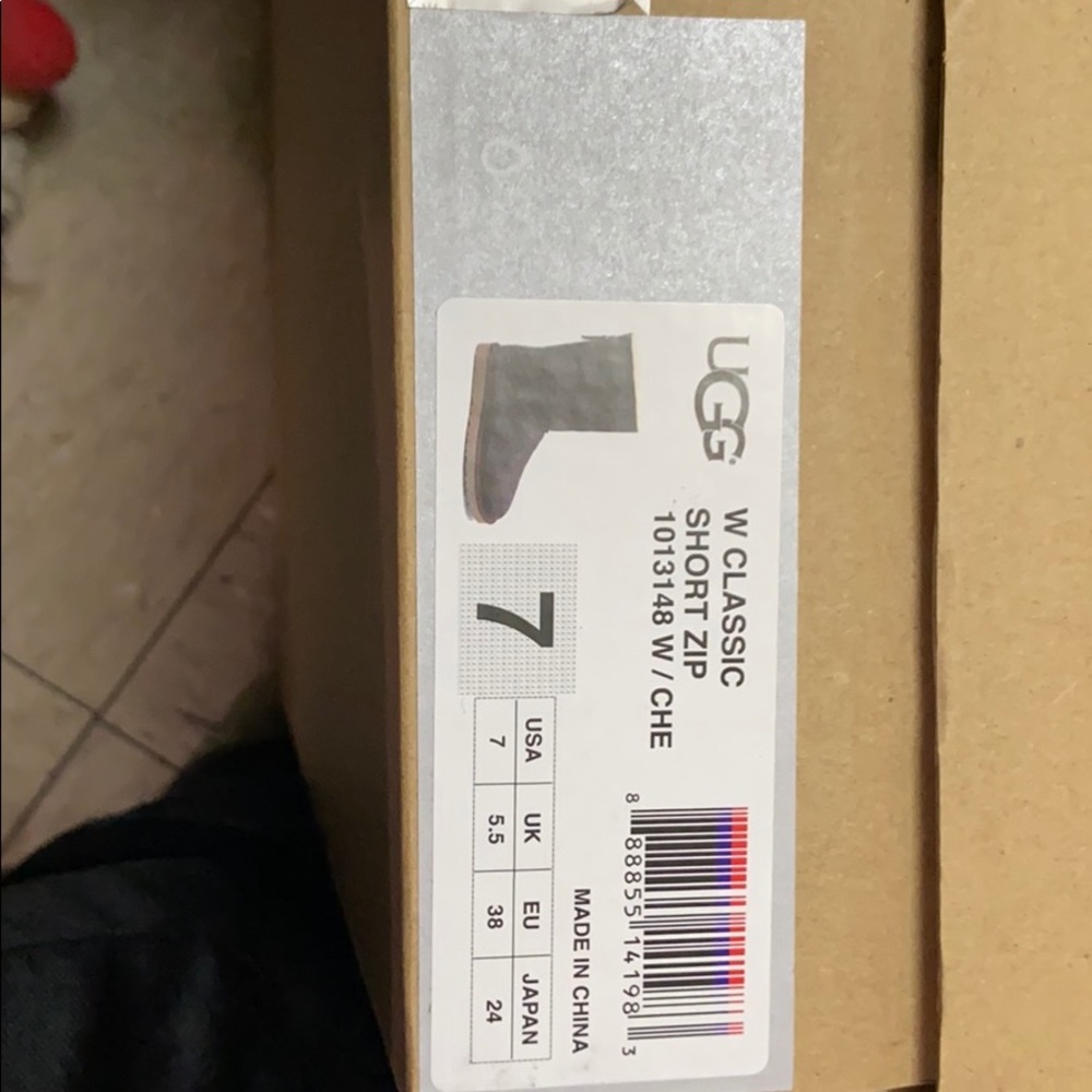 Brown leather classic uggs w zipper on the back.